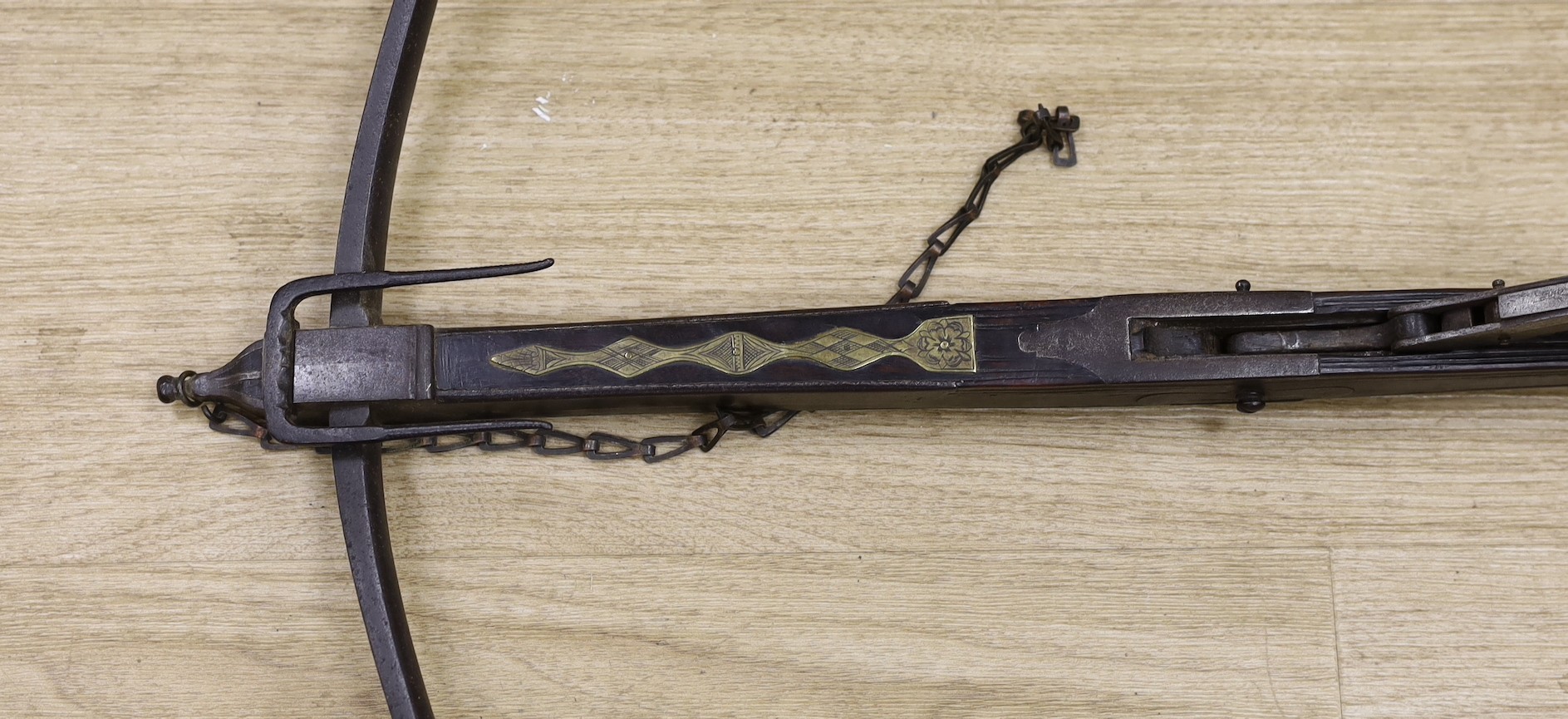An 18th century English mahogany, brass and iron mounted bullet crossbow, 69cm, pommel end